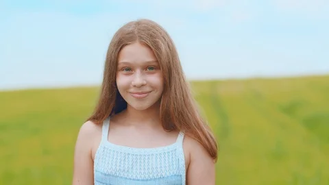 Close up view of adorable sweet blue-eyed little girl in white dress looking Stock Footage 113045384