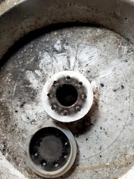 Close-up view of an aerator diffuser displaying significant wear and residue  Stock Photos