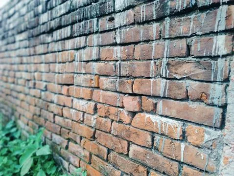 A close-up view of an aged brick wall showing weathered texture, mortar joi.. Stock Photos