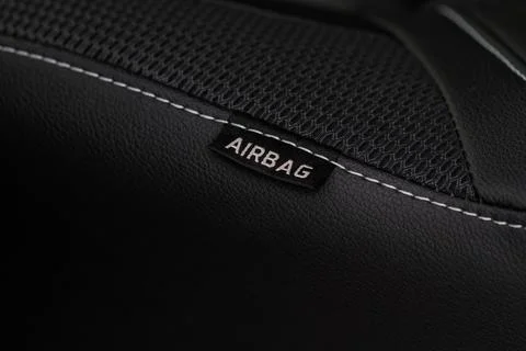 Close up view of airbag label on the side of a car seat. Airbag safety system Stock Photos