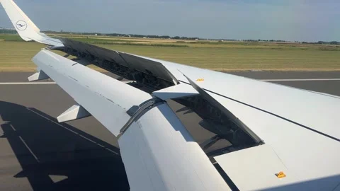 Close-up view of an airplane wing with deployed spoilers during landing Stock Footage 346098553