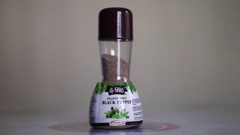 Close up view of Aji Shio Black Pepper bottle on a table with natural light. Stock Footage 128488786