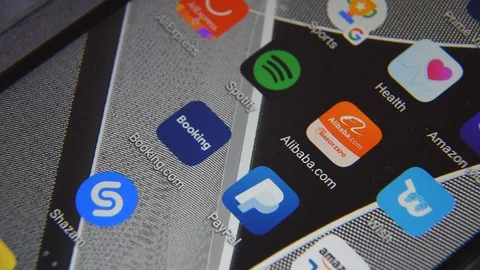 Close-up view of Alibaba app on an Android smartphone, including other icons. Stock Footage 128269359