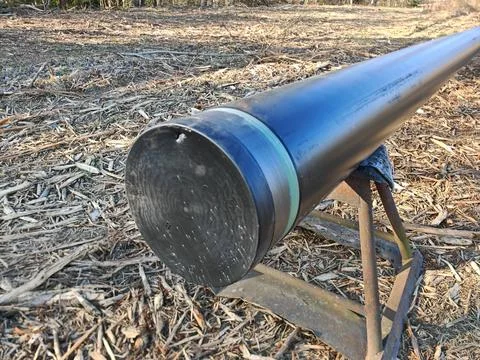 Close view along a large black plastic pipeline during installation Stock Photos