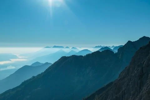 A close up view on the Alpine chains shrouded in the morning fog, seen from.. Stock Photos