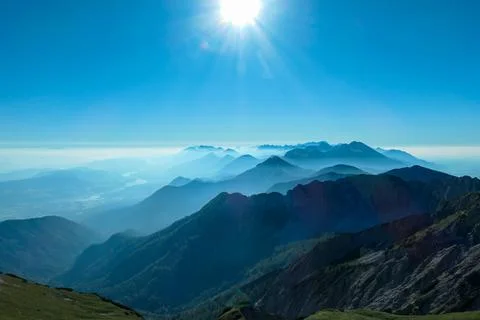 A close up view on the Alpine chains shrouded in the morning fog, seen from.. Foto stock