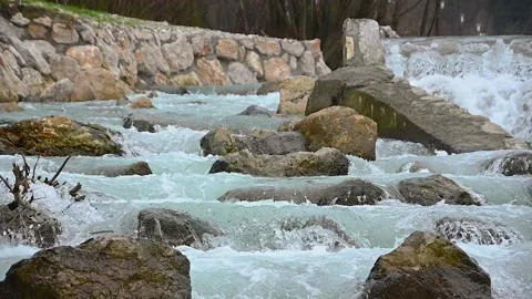 Close up view of Alpine river flowing on manmade spillway Stock Footage 146226875