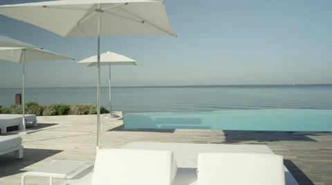 CLOSE UP: View of amazing high class pool lounge club in beach oceanfront hotel Stock Footage 68720683