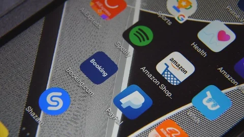 Close-up view of Amazon app on an Android smartphone, including other icons. Stock Footage 128269255