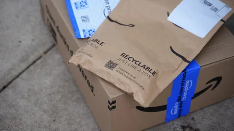 Close up view of Amazon delivery package with padded envelopes left on a Stock Footage 330985981