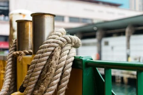 Close view of anchoring ropes on a ferry pulling into a harbour city wharf Stock Photos