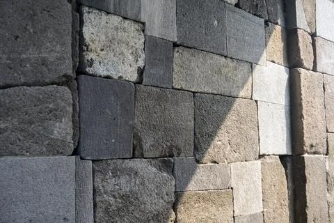 Close-up view of ancient andesite stone block wall texture on a historical Stock Photos