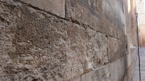 Close-up view of an ancient stone church wall with weathered texture and pe.. Stock Footage 345044427