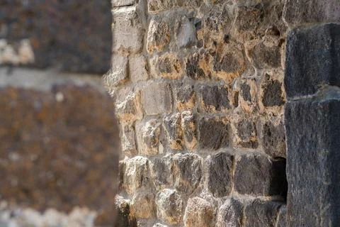 Close-up view of ancient stone wall with textured surfaces and varying colors 스톡 사진