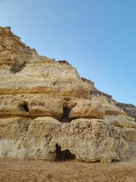 Close-up view of ancient weathered limestone cliffs featuring natural caves,  Stock Photos