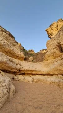 Close-up view of ancient weathered limestone cliffs featuring natural caves,  Fotos de archivo