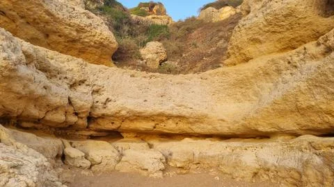 Close-up view of ancient weathered limestone cliffs featuring natural caves,  Фото