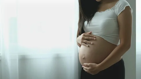 Close up view and portrait of young pregnant woman stand with white curtain Stock-Footage 122274241