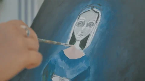 Close up view and side movement of hand holding artist brush painting picture Stock Footage 130617268