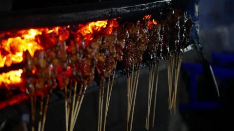 Close up view and vertical view of grilling Indonesian chicken satay in tra.. Stock Footage 294278448