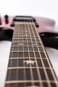 Close-up view of an angled, digitally altered electric guitar neck with dar.. 写真素材