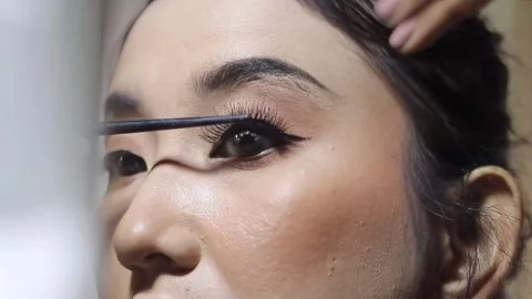 Close-up view of applying mascara to lashes for a beauty look Stock Footage 313165215