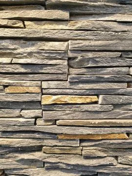 Close-up view of an artificial wall made of stone slabs. Stock Photos