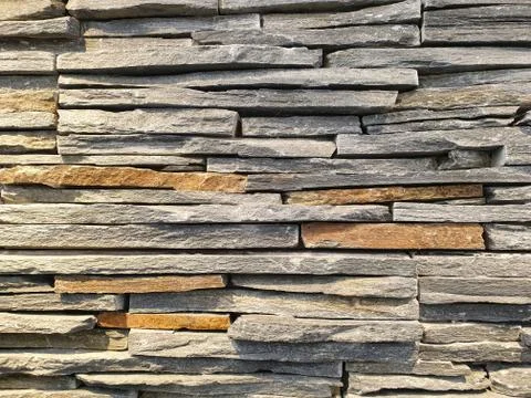 Close-up view of an artificial wall made of stone slabs. Stock Photos