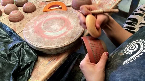 Close Up View of Artisan Engraving Clay Pottery by Hand in Traditional Workshop Stock Footage 337920548