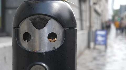 A close-up view of an ashtray on a sidewalk. Video stock 107954774