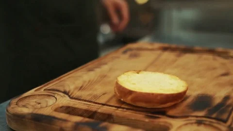 Close up view of assembling a beef hamburger lunch with fresh lettuce being Stock Footage 82501051