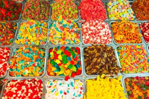 Close up view of assorted colorful different shape jelly candies on market pl Stock Photos