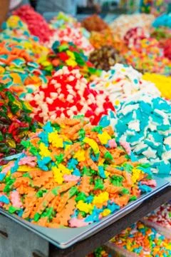 Close up view of assorted colorful different shape jelly candies on market pl Stock Photos