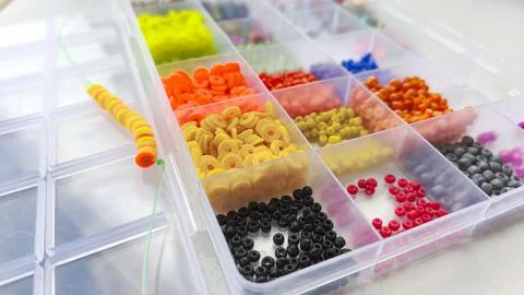 Close-up view of assorted craft beads in vibrant colors organized Fotos Stock