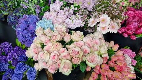 Close-up view of assorted fresh flowers in a florist shop, featuring pastel pink Stock Photos