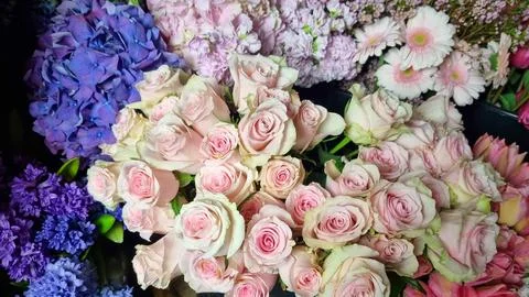 Close-up view of assorted fresh flowers in a florist shop, featuring pastel pink Stock Photos
