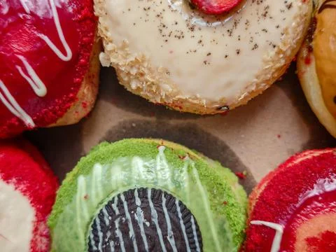 Close Up View of Assorted Gourmet Glazed Donuts with Colorful Toppings 库存照片