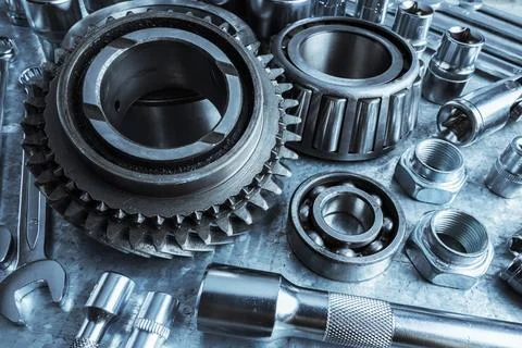 Close-up view of assorted metal tools and mechanical parts on a workbench Stock Photos