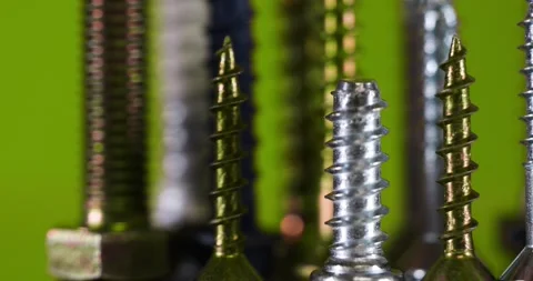 Close up view of assorted screws on green background. 스톡 동영상 255993421