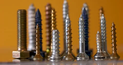 Close up view of assorted screws on yellow background. panning shot. Stock Footage 238482644
