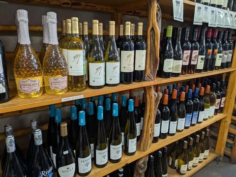 Close view of assorted wines on handcrafted wooden shelf Fotos de archivo