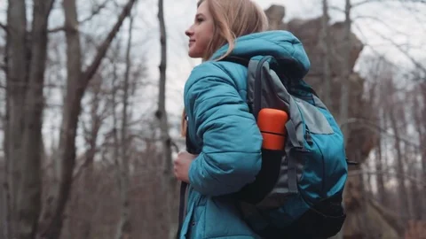 Close up view of attractive blonde backpacker walking in the autumn forest Stock Footage 73883876
