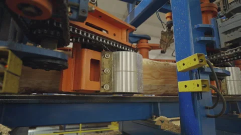 Close-up view of automated rollers processing heavy wooden beam in a wood Stock Footage 304306280