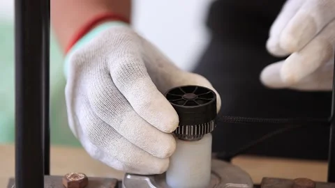 Close up view of Automatic car headlight manufacturing assembly manual process Stock Footage 300936661