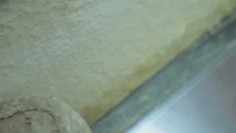 Close up view of an automatic moving line of baked rolling loaves of bread Stock Footage 77518497