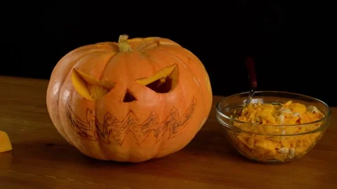Close-up view from the back of a man with a beard in a shirt carving a face o Stock Footage 272459228