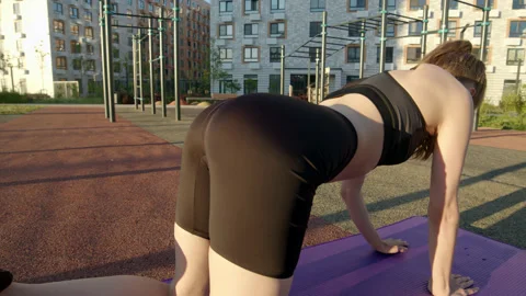 Close up view from back on slender sexy athletic young woman is doing warm-up on Stock Footage 207857706