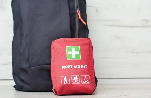 Close up view with a backpack along with a first aid kit ready for the mounta Stock Photos