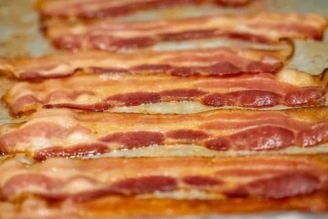 Close up view of bacon on a baking sheet 스톡 사진