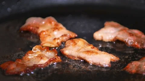 Close-up view of bacon slices in frying pan. time-lapse Stock Footage 166528228